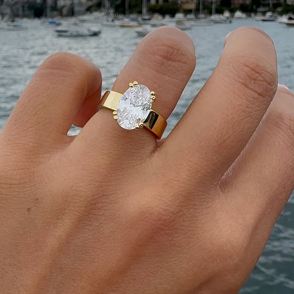 3ct lab oval on a wide gold band