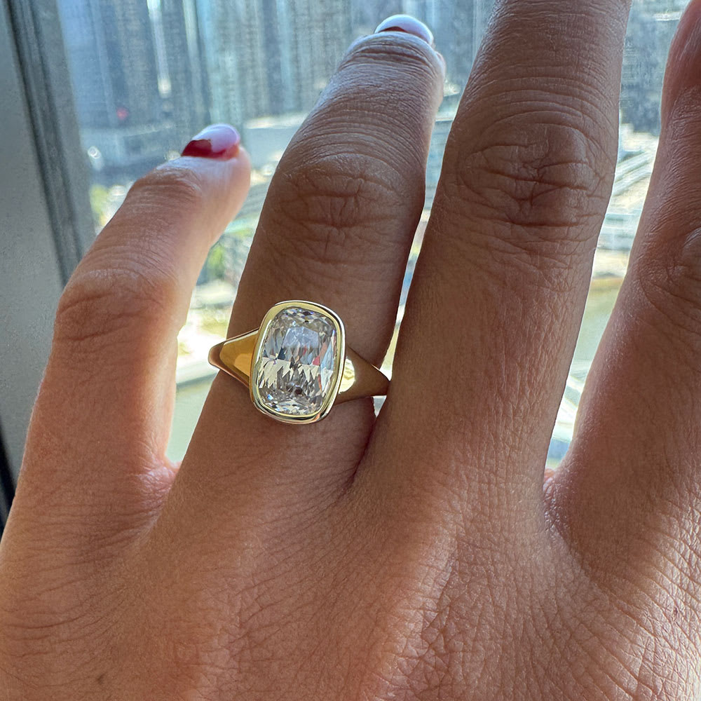 Elongated cushion in bezel setting