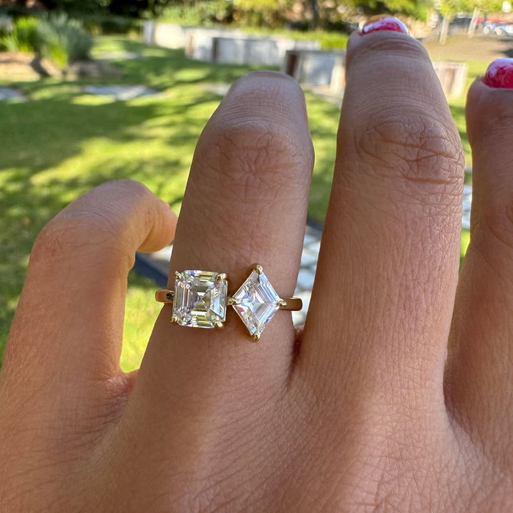 Step cut two stone engagement ring