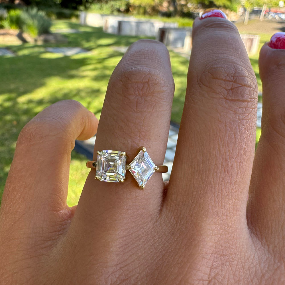 Step cut two stone engagement ring