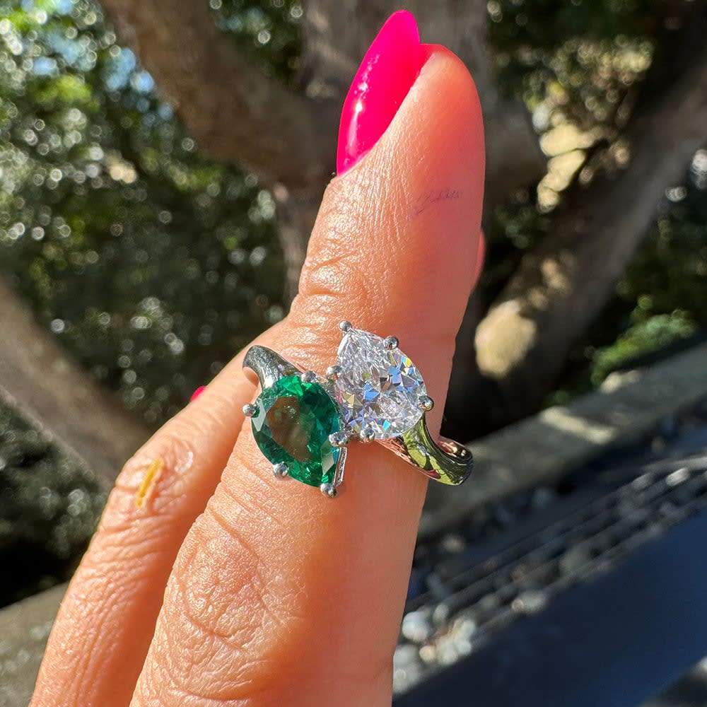 Green emerald and pear diamond ring