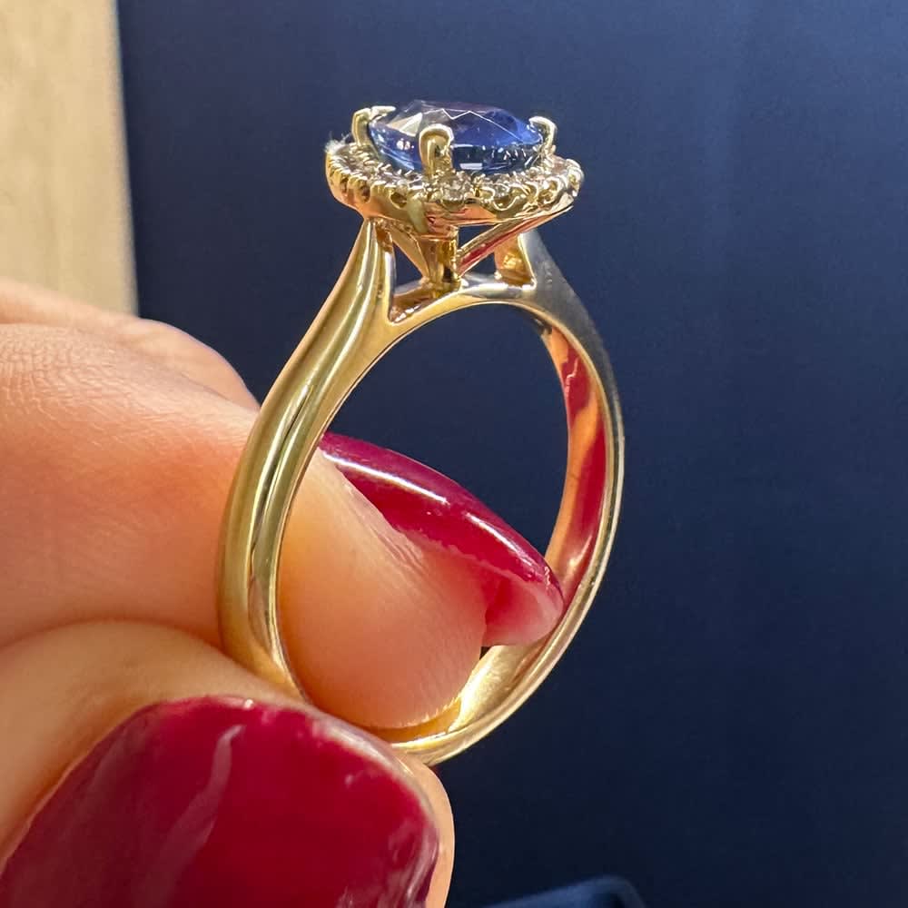 Natural blue sapphire with halo and plain band