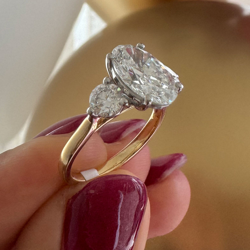 Oval with round diamond trilogy