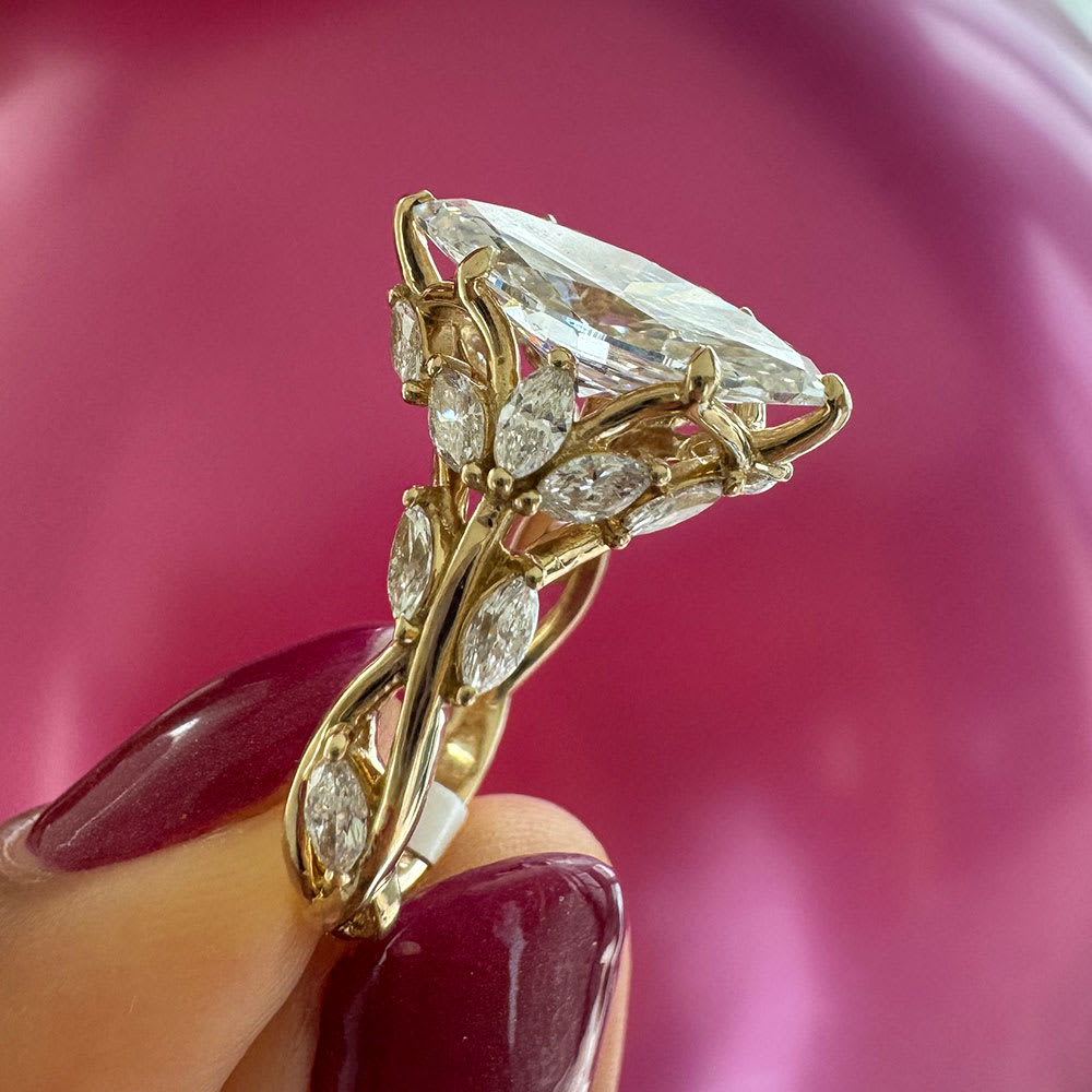 Marquise cut engagement ring with detail band