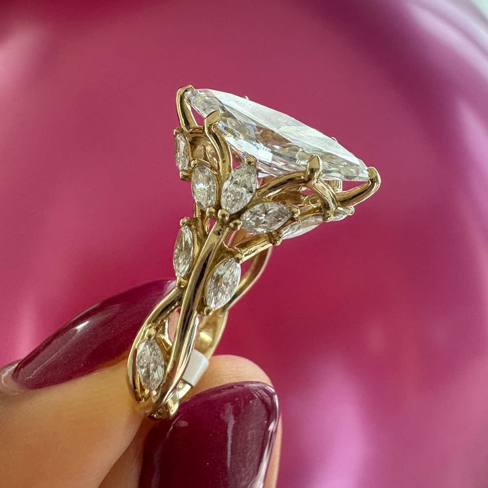 Marquise cut engagement ring with detail band