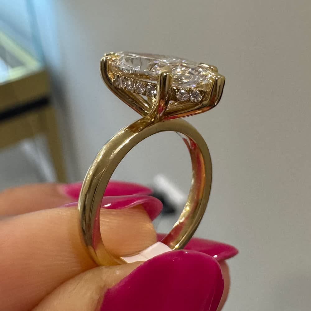 Marquise set with hidden halo on a gold band