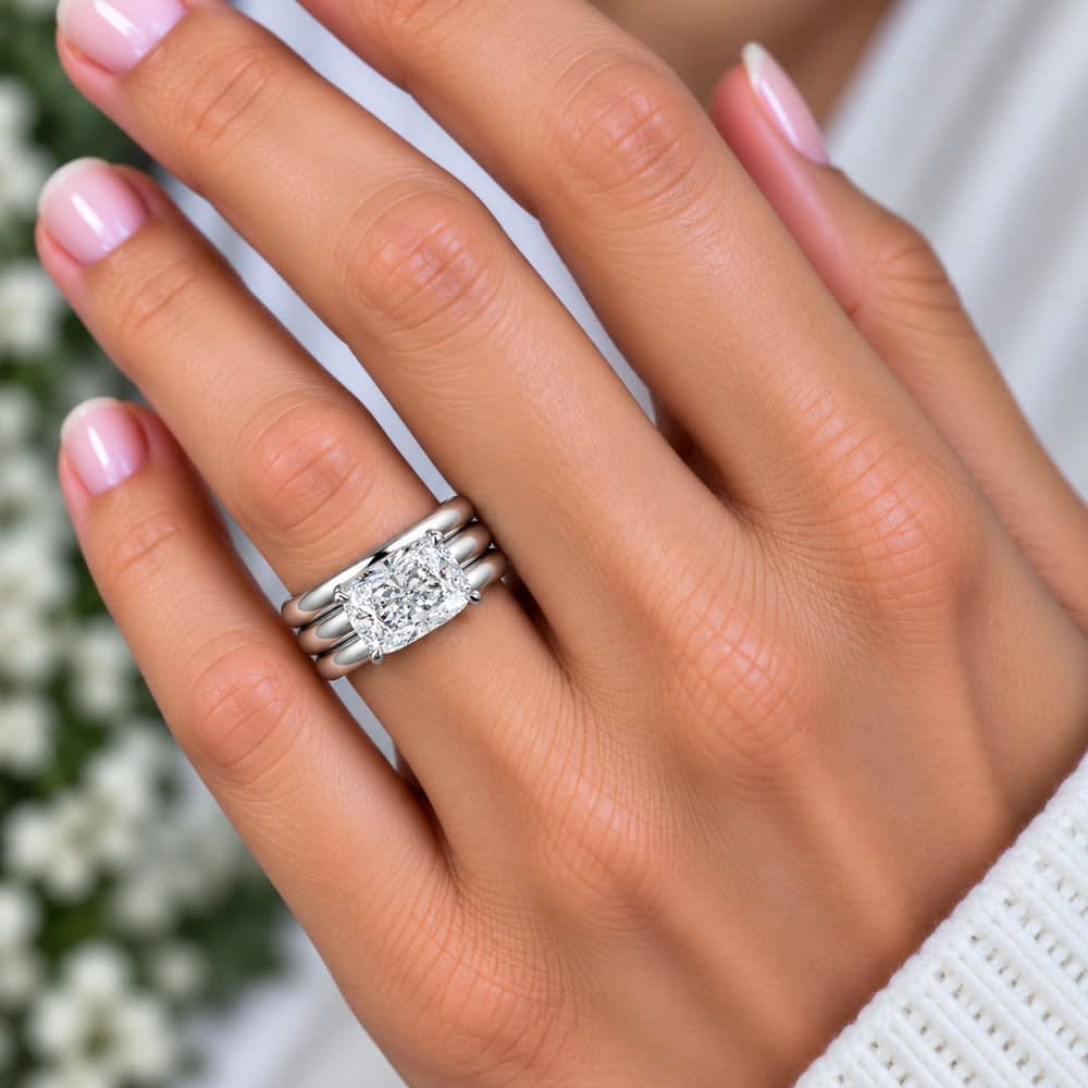 elongated cushion set on a solid wide gold band