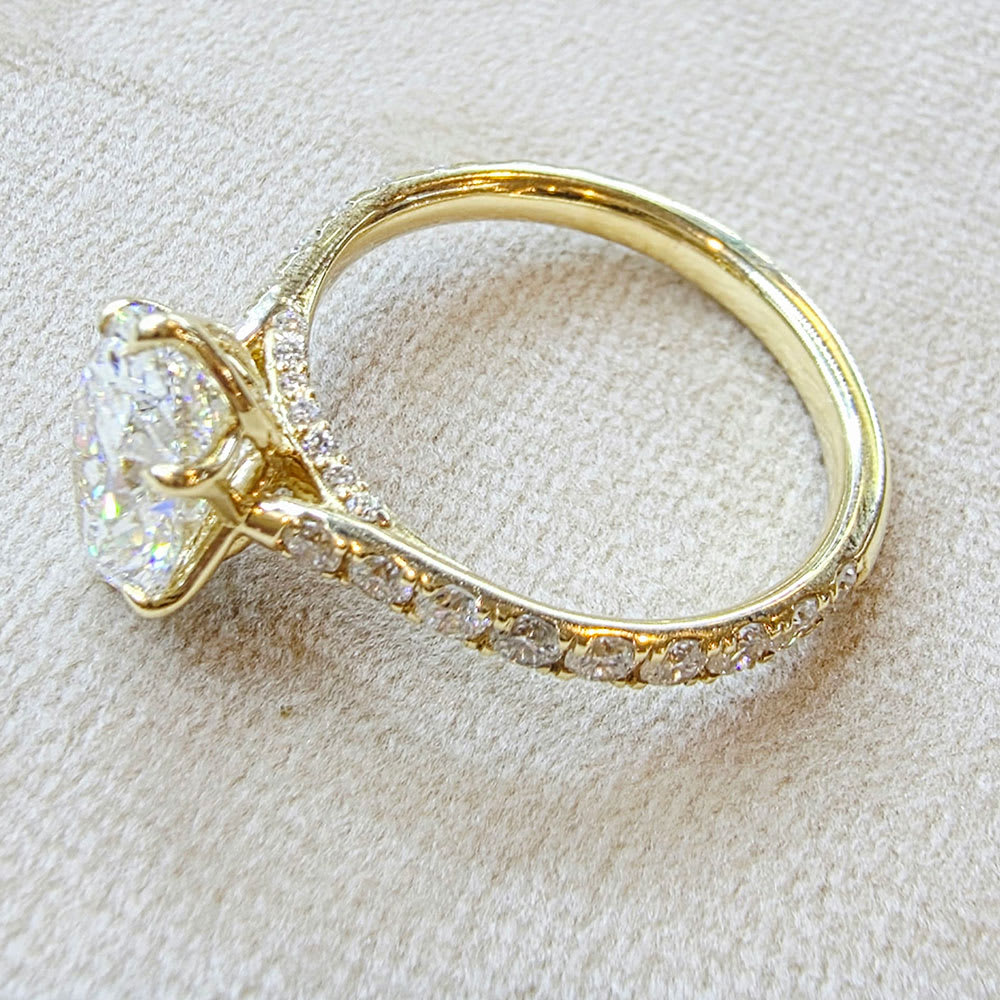 oval diamond set with tiger prongs and tulip setting
