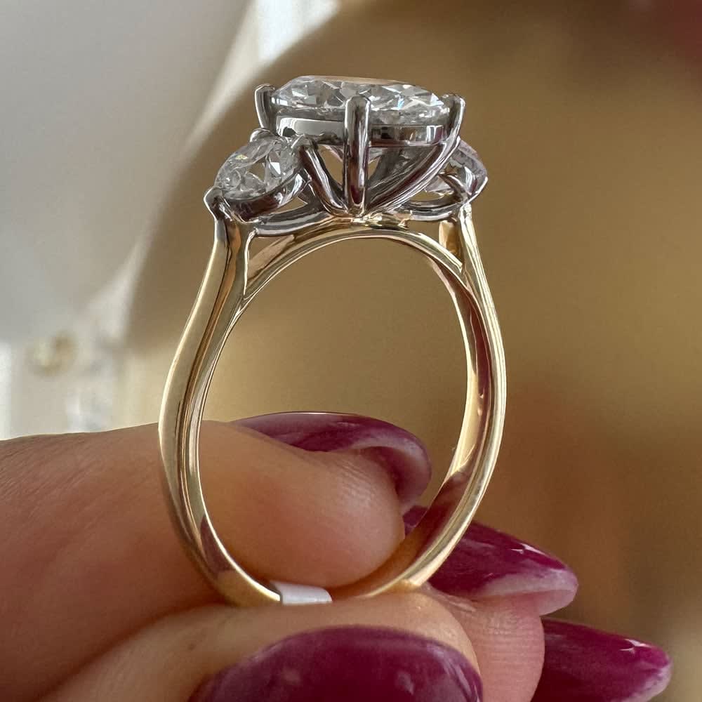 Oval with round diamond trilogy
