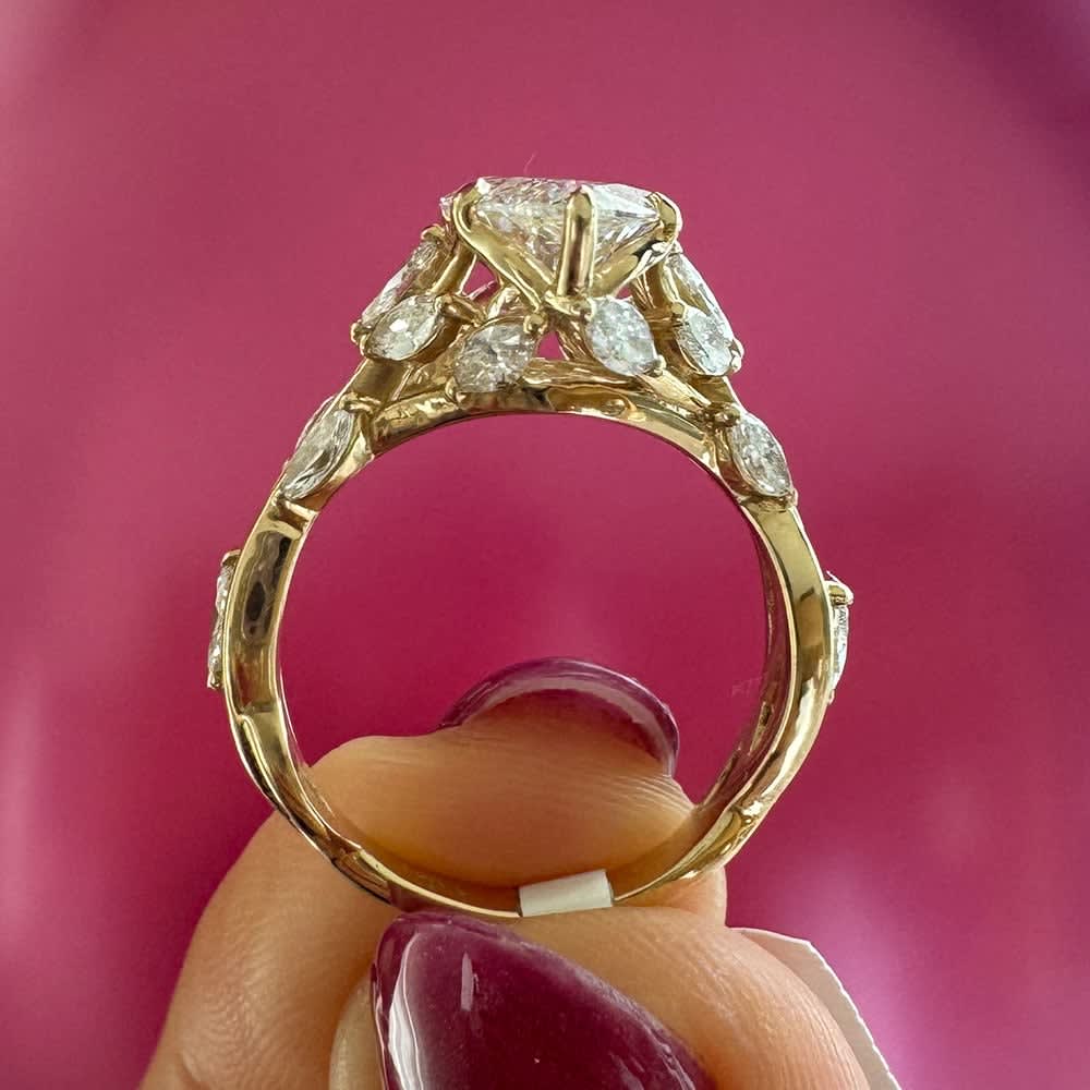 Marquise cut engagement ring with detail band