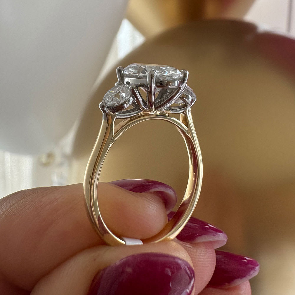 Oval with round diamond three stone ring