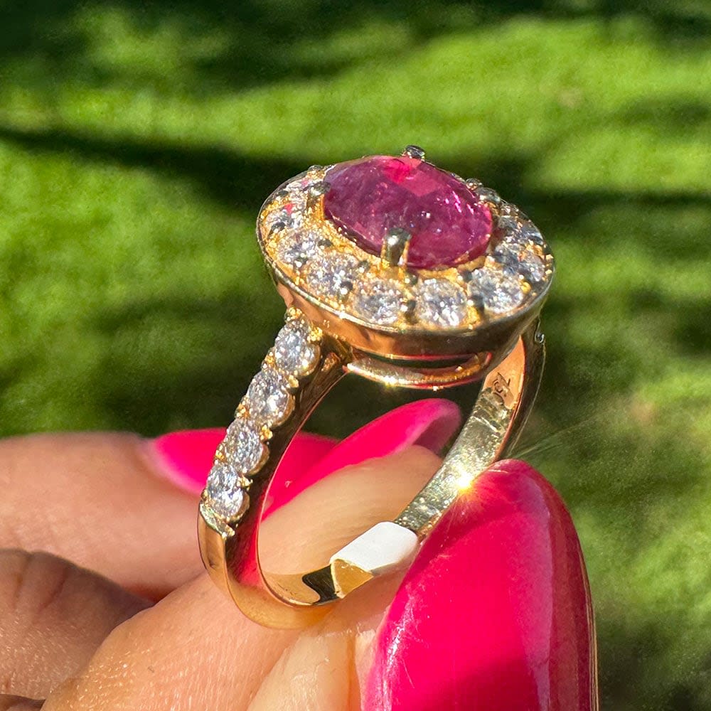Natural ruby with halo on a gold band