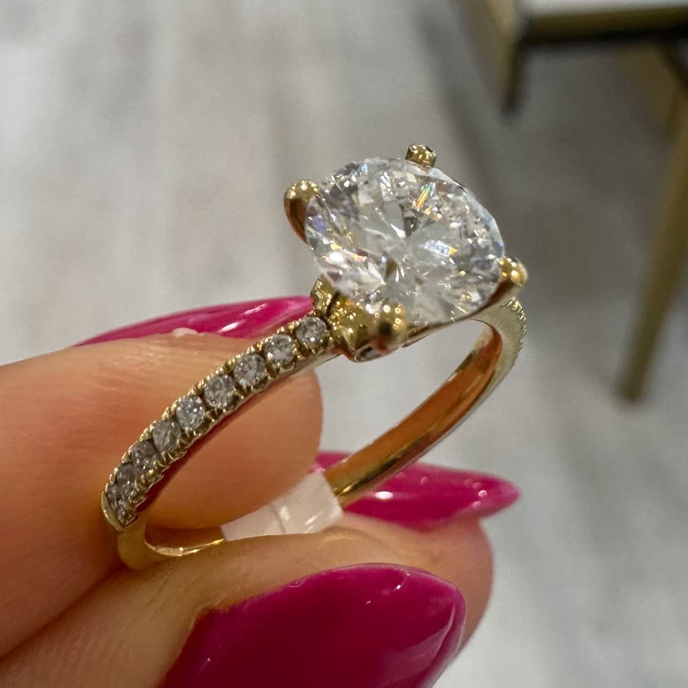 Round diamond on a diamond band yellow gold