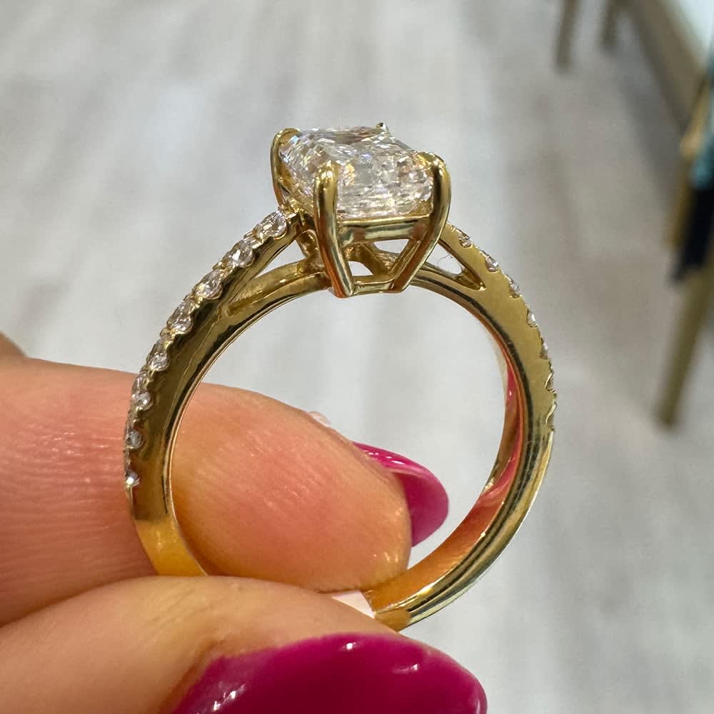 Emerald cut on a diamond band yellow gold