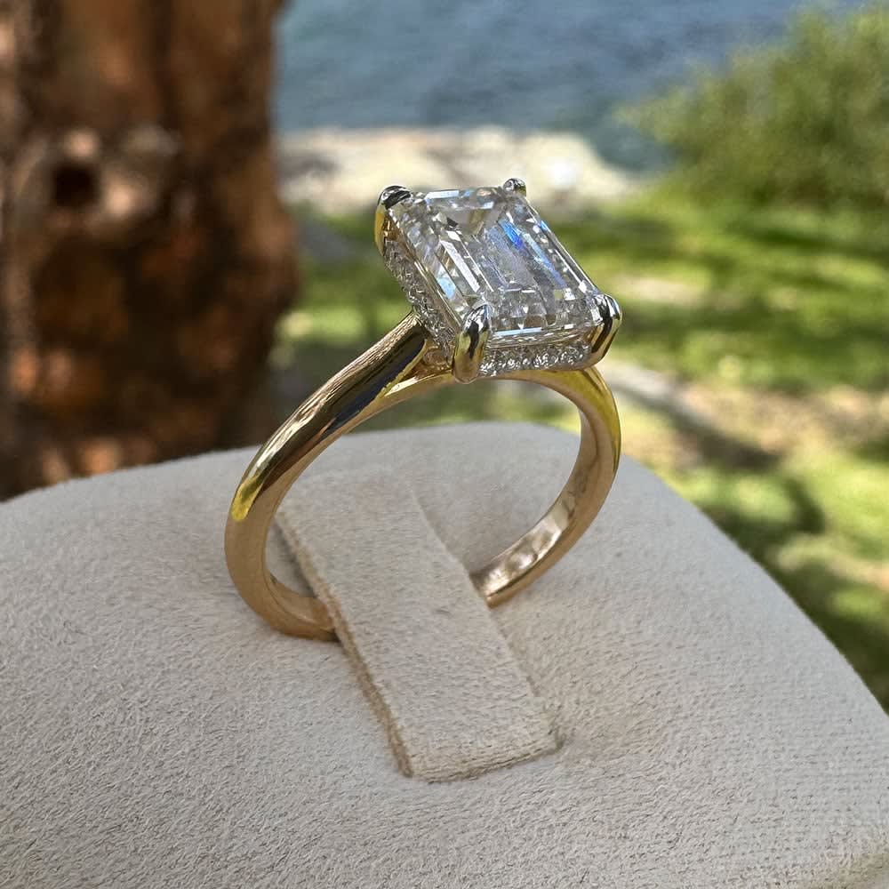 18k yellow gold ring set with lab emerald cut white diamond