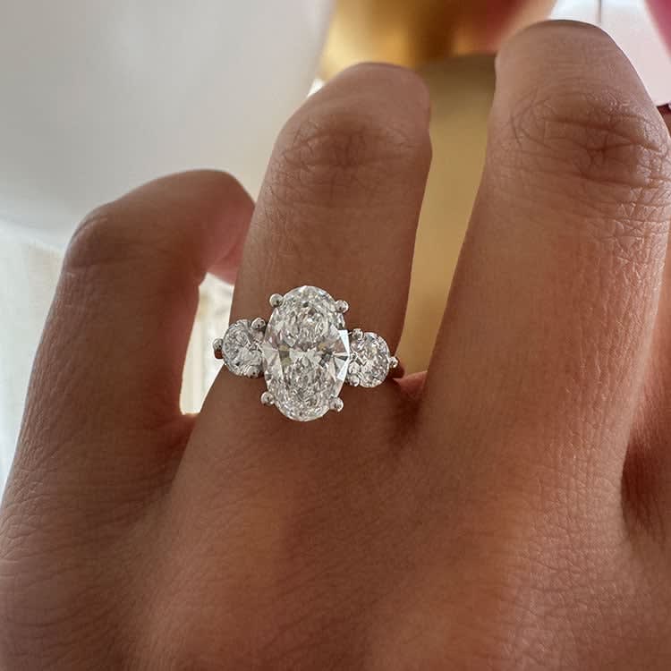 Oval with round diamond three stone ring