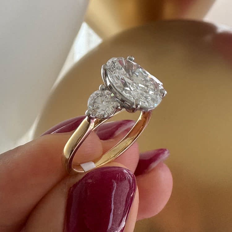 Oval with round diamond three stone ring