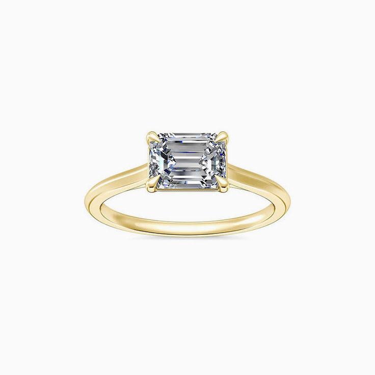 East to west emerald engagement ring