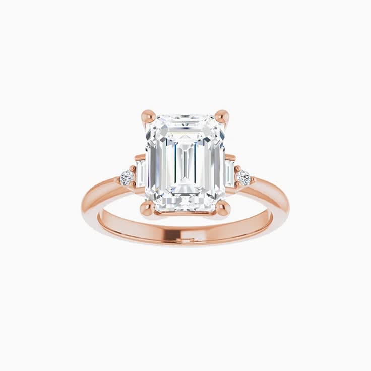 Emerald trilogy engagement ring
