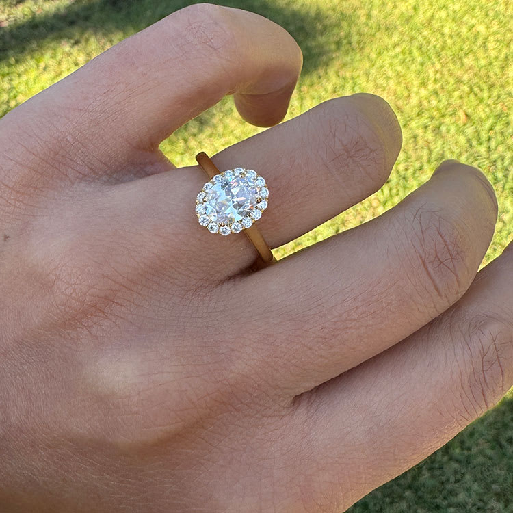 Oval halo diamond on a plain band engagement ring