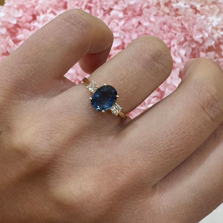 Oval blue sapphire trilogy ring