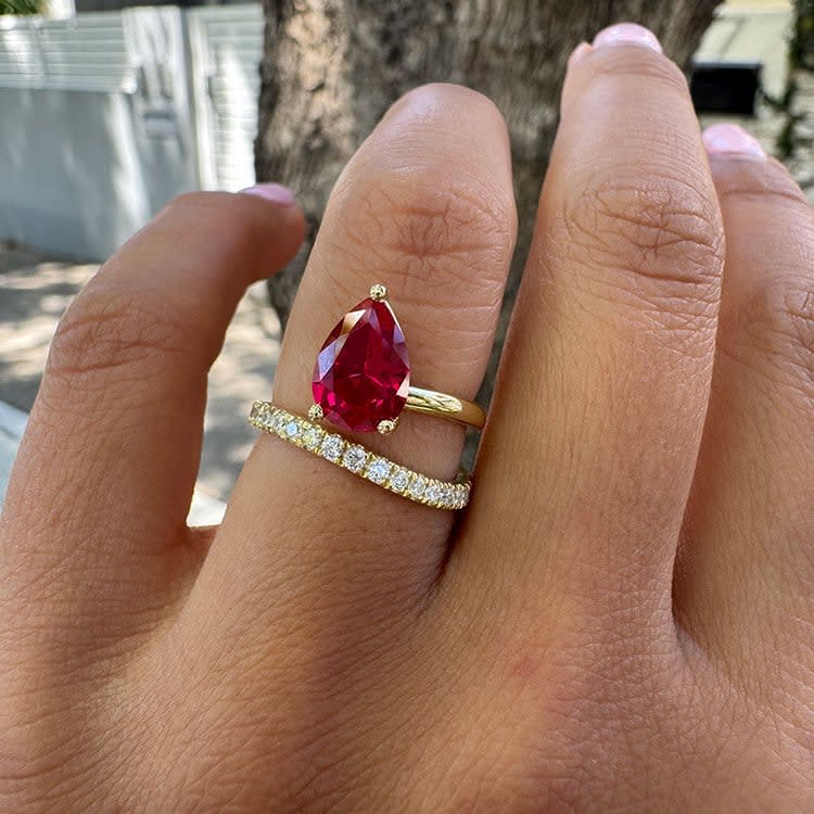 Lab Ruby set in a wave diamond band