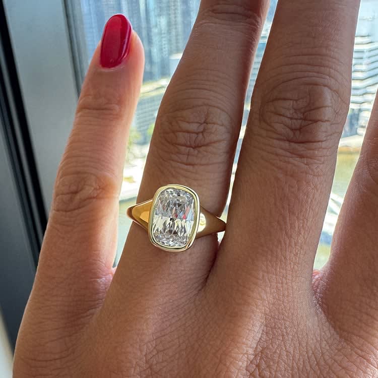 Elongated cushion in bezel setting