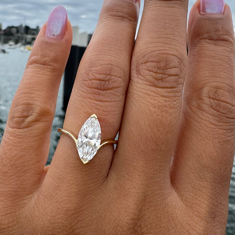 Petite engagement ring set with marquise cut diamond