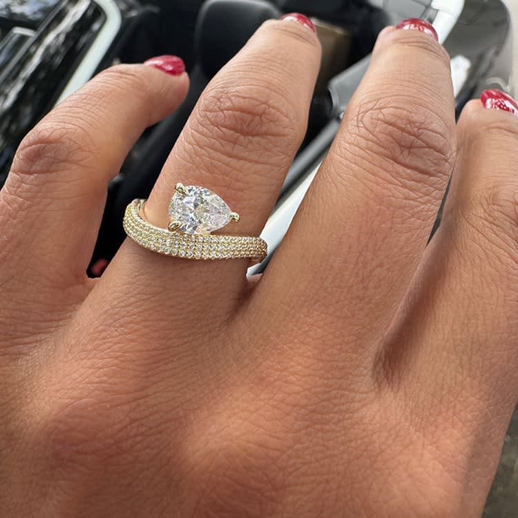 Triple diamond band with a pear diamond