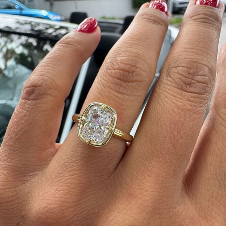 Elongated cushion on a bezel setting