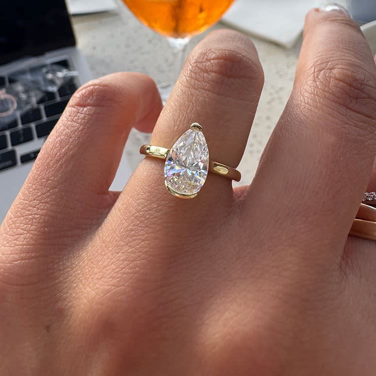 Pear cut diamond set in partial bezel setting