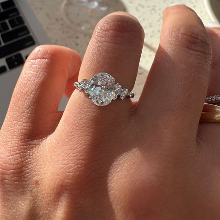 Oval cut diamond with diamonds on the band