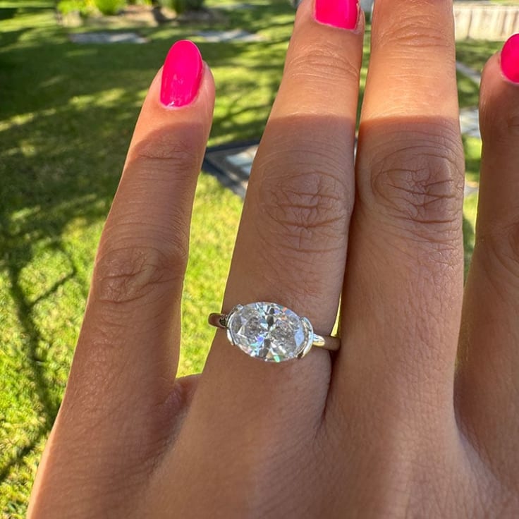 Partial bezel oval engagement ring