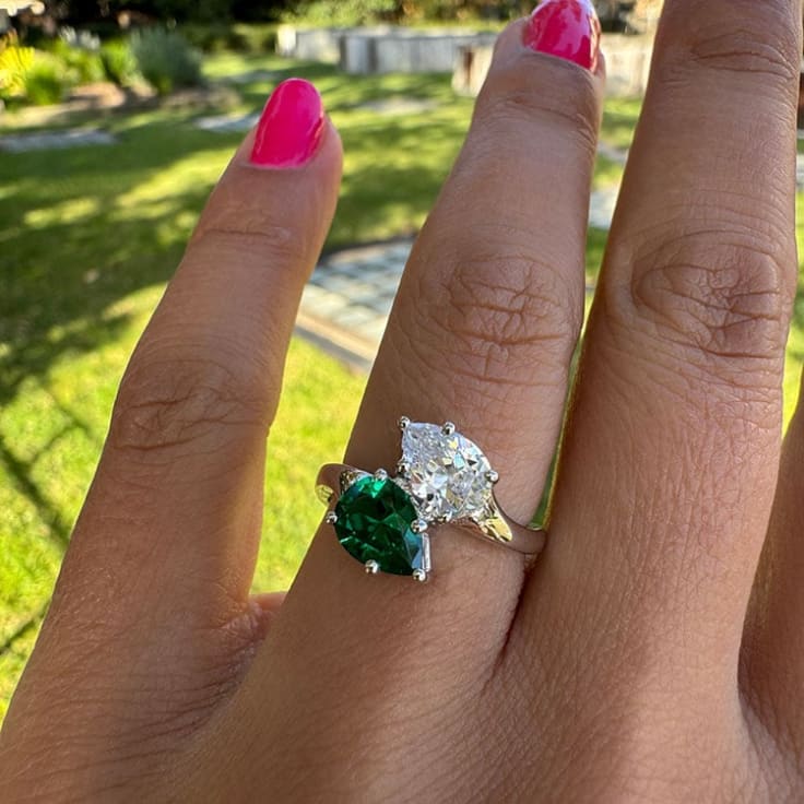 Green emerald and pear diamond ring