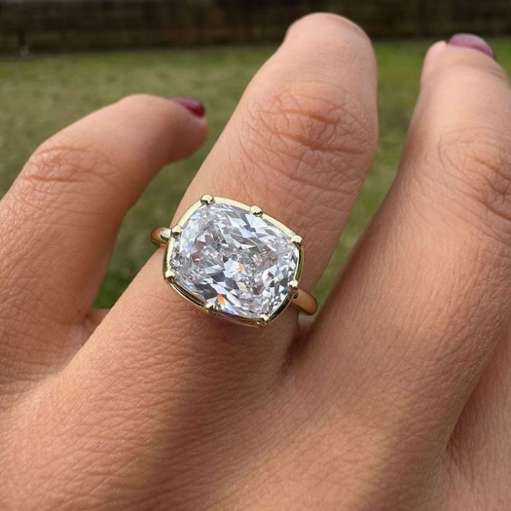 4ct cushion on a solid gold ring