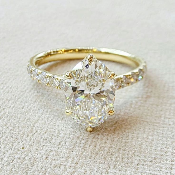oval diamond set with tiger prongs and tulip setting