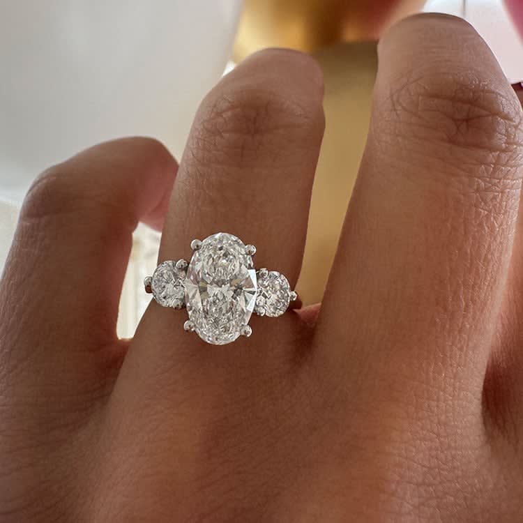 Oval with round diamond trilogy
