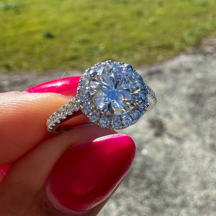 Round diamond with a halo classic engagement ring