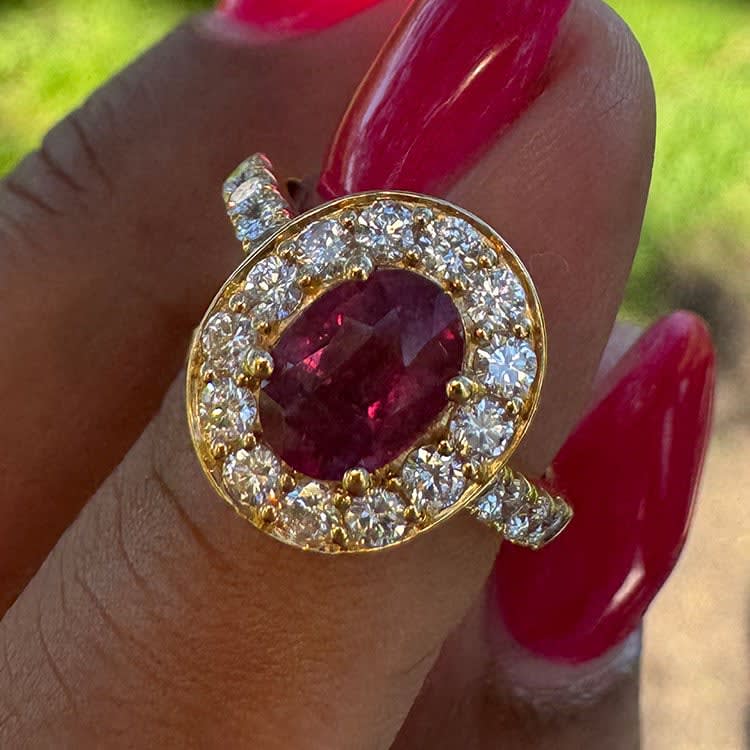 Natural ruby with halo on a gold band