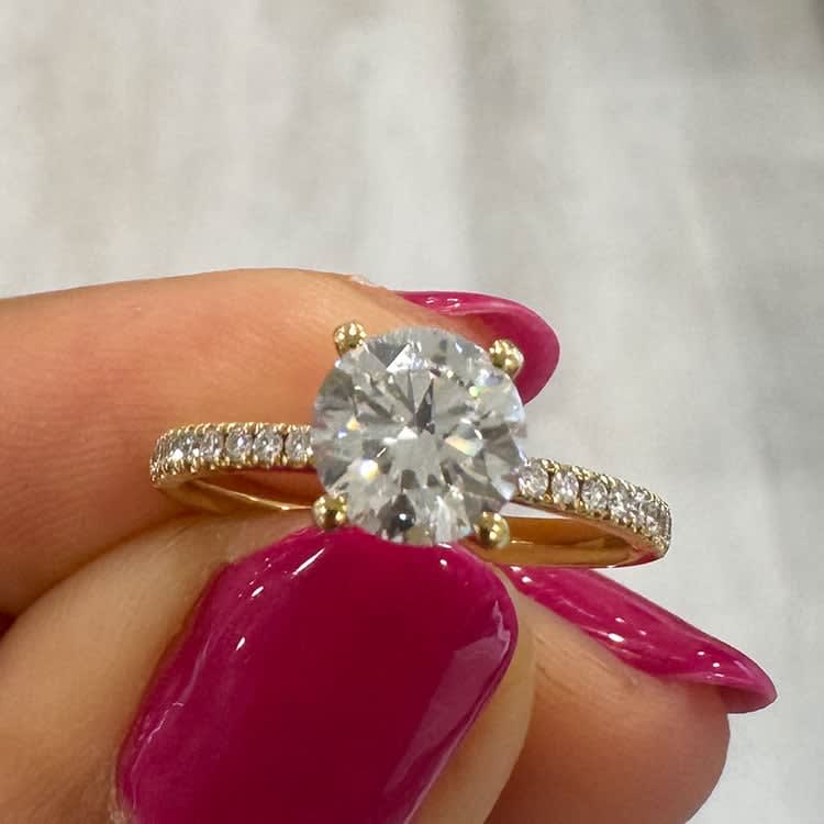 Round diamond on a diamond band yellow gold