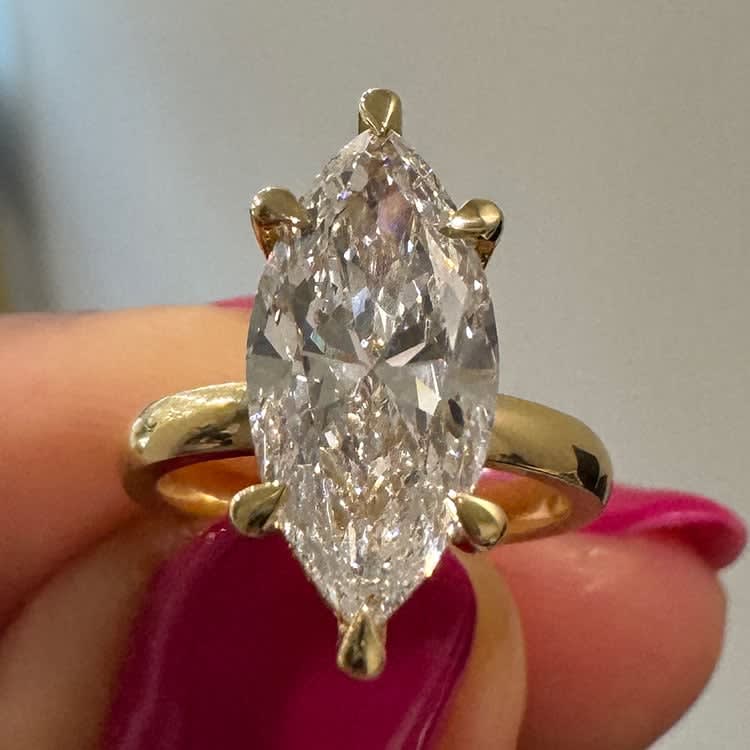 Marquise set with hidden halo on a gold band