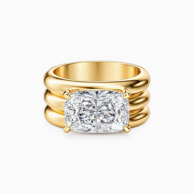 elongated cushion set on a solid wide gold band