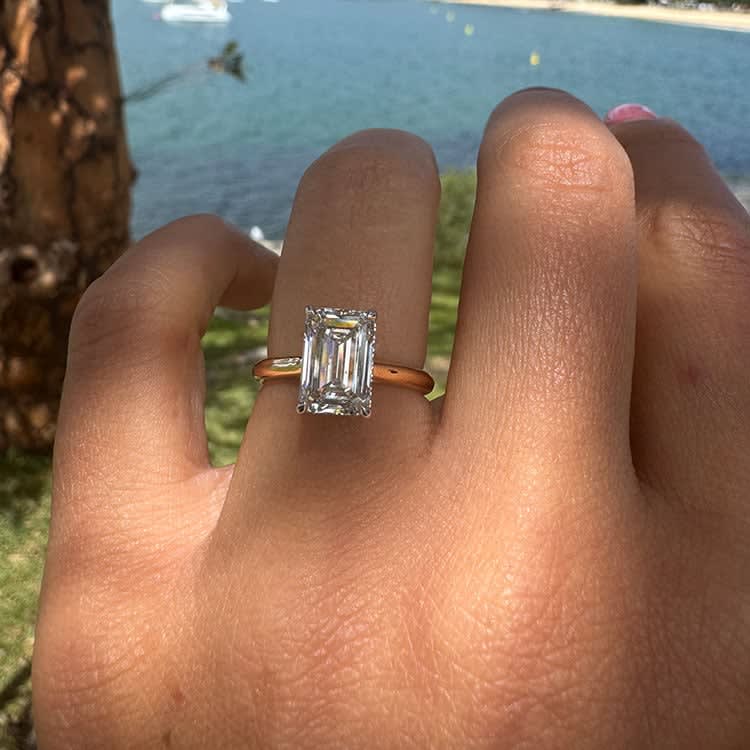 18k yellow gold ring set with lab emerald cut white diamond