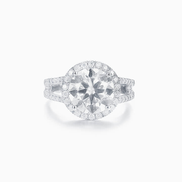 Round Brilliant cut with a diamond halo on a split band Enagement ring