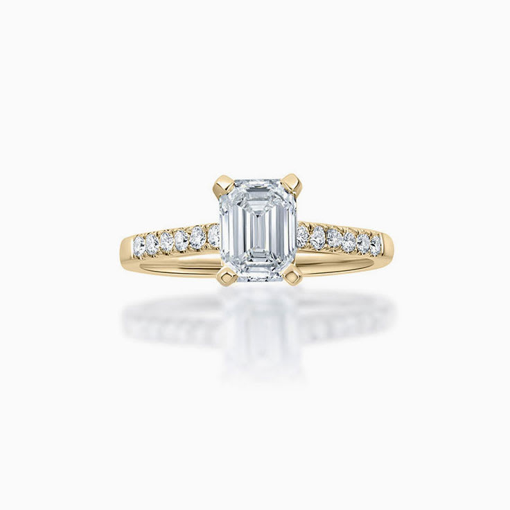 Emerald cut diamond engagement ring on a pave band