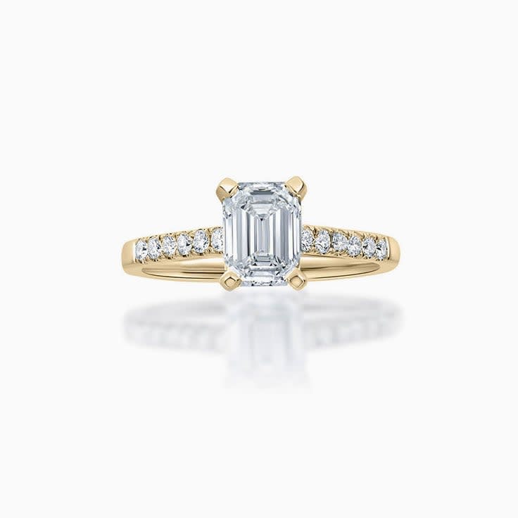 Emerald cut diamond engagement ring on a pave band