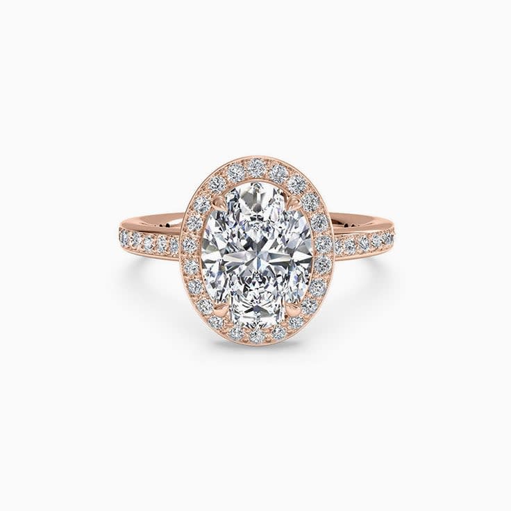 Oval Cut engagement ring with a diamond halo and diamond band