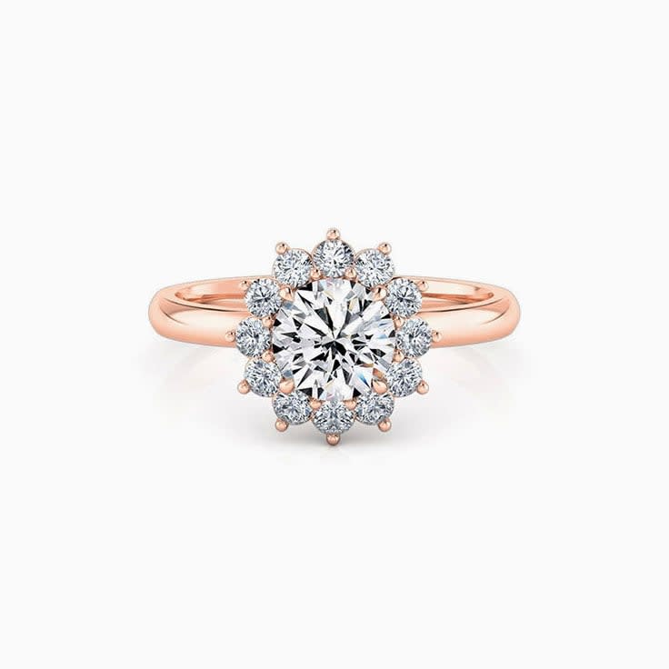 Round brilliant cut engagement ring with floral halo setting