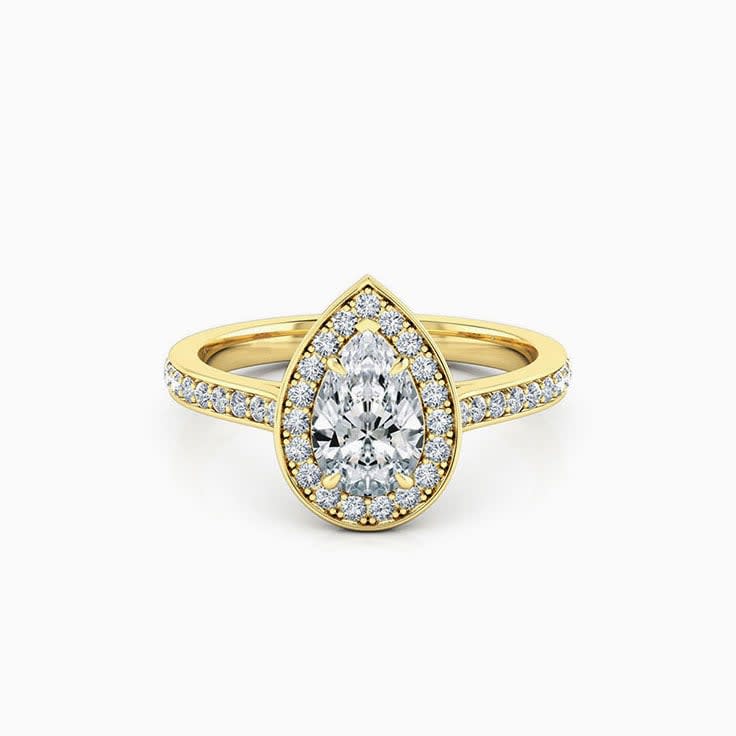 Pear cut diamond engagement ring with pave halo
