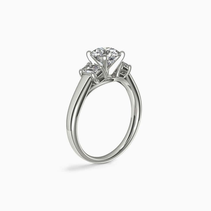Classic Round Diamond And Emerald Cut Side Stone Engagement Ring